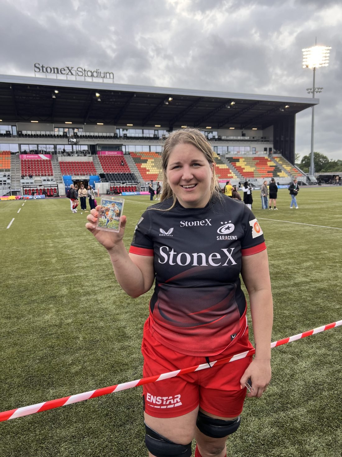 A Saracens supporter wearing a Poppy Cleall Made By Stories card on a lanyard