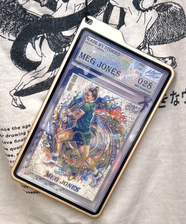 A Meg Jones Made By Stories trading card worn as a wearable lanyard pendant